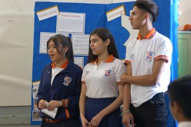 Monica (left) in full presentation with her classmates