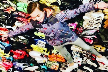 Zoe among the multitude of booties she managed to collect to donate.