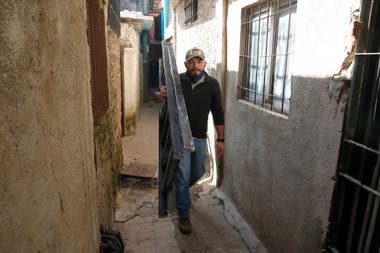 Hayder Armin Flores walks the corridors of Villa 21-24, with two friends he set up an enterprise that offers Internet connection where no other large provider reaches
